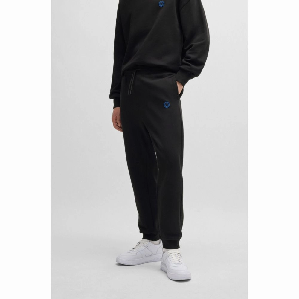 Cotton-terry tracksuit bottoms with Happy HUGO logo patch