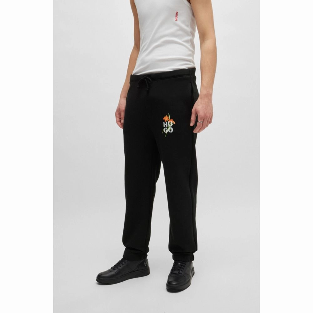 Relaxed-fit tracksuit bottoms with floral logo artwork