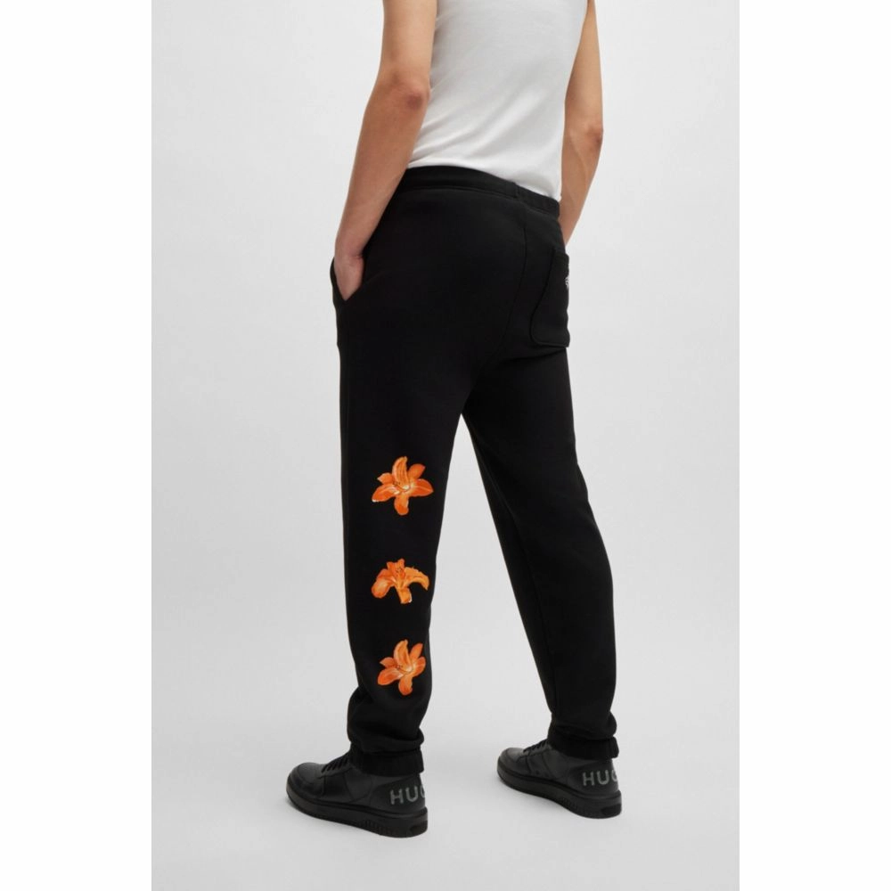 Relaxed-fit tracksuit bottoms with floral logo artwork